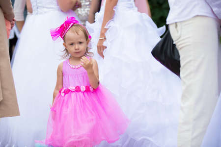 Russia. Moscow, August 27, 2017. Imailovsky park.Parade of brides. Beautiful little girl in with a bouquet of flowers at a wedding.のeditorial素材