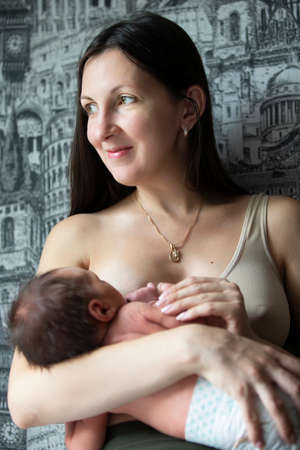 Portrait of a breastfeeding woman with a baby.