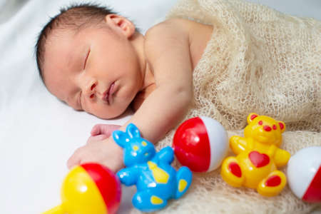 The newborn baby sleeps sweetly.The child is seven days old.