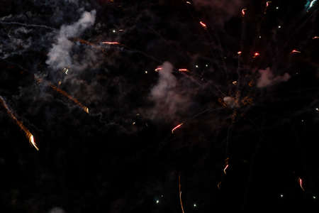 Smoke and spots of fireworks on a black background.