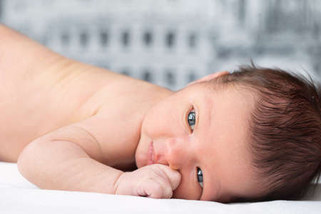 Close-up newborn baby portrait. A baby with smart eyes.