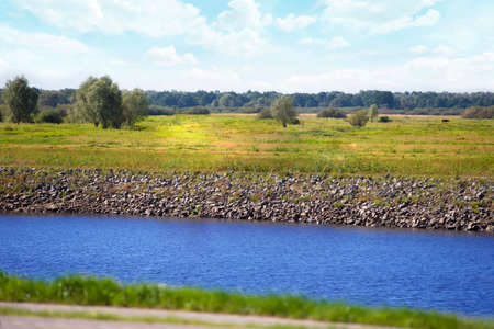 Beautiful nature with river meadows and blue sky.