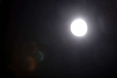 Lens flare light over black background.