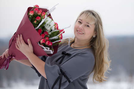 Happy woman with a bouquet of flowers