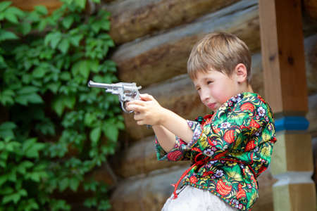 Russian boy in national dress with a gun.の写真素材