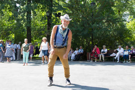 Russia, Moscow, July 29, 2018. Central nursing home. Dance floor to someone over sixty years.. An elderly pensioner is dancing. A man in the age happy life. Dancing in the House of the Elderlyのeditorial素材