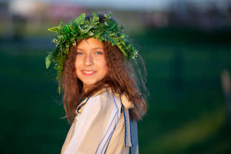 08/29/2020 Belarus, Lyaskovichi. A holiday in the city. A girl in a wreath of herbs at the Ivan Kupala holiday.のeditorial素材