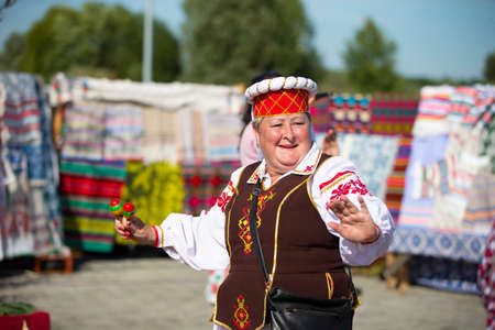 08/29/2020 Belarus, Lyaskovichi. A holiday in the city. A woman in Slavic national dress is dancing.のeditorial素材