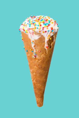 Ice cream cone close up. White ice cream scoop in a waffle cone on a blue background. Sweet dessert...