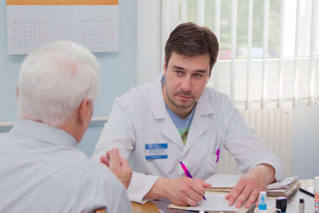 Belarus, Gomel, May 31, 2017. Central Hospital. Doctor and patient. An elderly man in the doctors office. The man at the reception in the medical office.のeditorial素材
