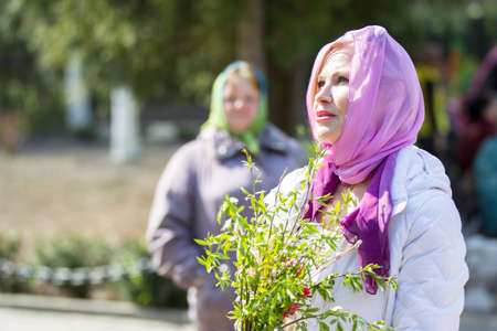 Belarus, Gomel, April 21, 2019. Palm Sunday is a church holiday.Beautiful woman in a headscarf with...