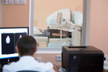 Belarus, Gomel, June 01, 2017 Diagnostic hospital. The doctor makes magnetic resonance therapy to the patient. Diagnosis of diseasesのeditorial素材