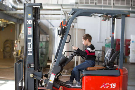 Belarus, the city of Mensk, April 12, 2019. Chemical production.The child controls the loader....