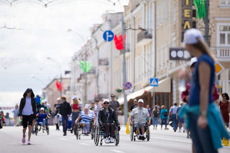 Belarus, the city of Gimel, July 03, 2019. Youth Festival.People in wheelchairs compete in the marathon on the streetsのeditorial素材