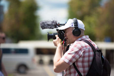Belarus, the city of Gimel, July 03, 2019. Youth Festival.Videographer works on a city streetのeditorial素材