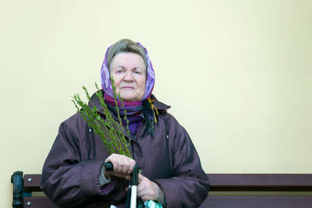Belarus, Gomel, April 21, 2019. Palm Sunday is a church holiday.A woman in a scarf with willow...