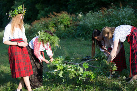 Belarus, the city of Gomel, July 07, 2018. Holiday Ivan Kupala.Slavic women make wreaths for the holidayのeditorial素材