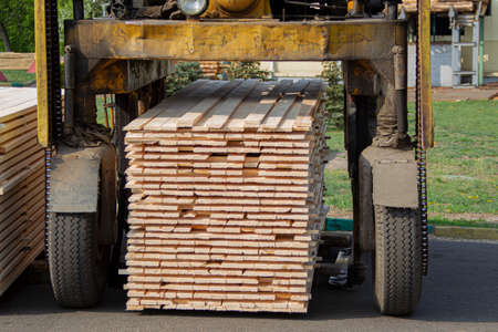 Loader with boards. Wood processing industry. Wood processing plantの写真素材