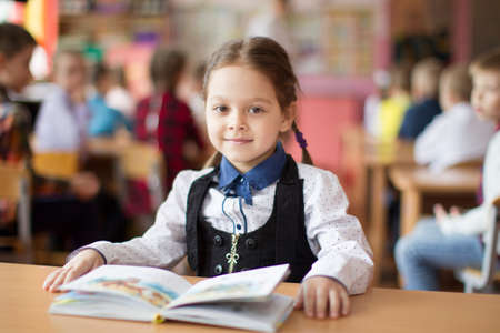 Belarus, the city of Gomil, May 10, 2019. Open day in kindergarten. Preschooler girl with a book. First-grader. Portrait of a kindergarten graduateのeditorial素材