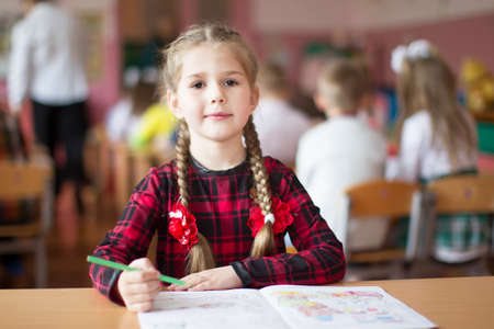 Belarus, the city of Gomil, May 10, 2019. Open day in kindergarten. Preschooler girl with a book. First-grader. Portrait of a kindergarten graduateのeditorial素材