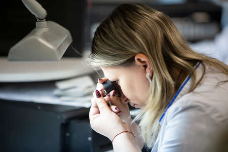 Belarus, the city of Gomil, April 24, 2019. Jewelry industry. A worker examines a diamond in a...