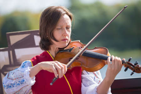 Belarus, the city of Gomil, September 14, 2019. City holiday. Slavic woman street musician....