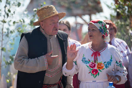 08 29 2020 Belarus, Lyaskovichi. Celebration in the city. Ukrainian elderly family in embroidered shirts. Husband and wife are Slavs in national dress.のeditorial素材