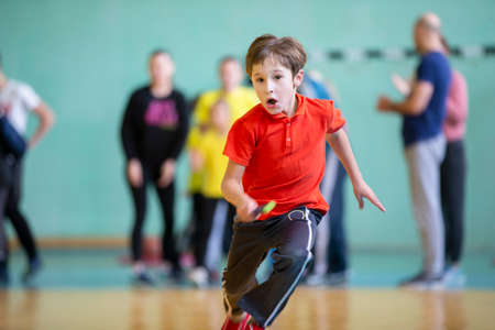 Child in the gym. A schoolboy in a physical education lesson. Relay race in elementary school. The...
