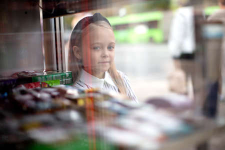 The little girls face through the shop window.の写真素材