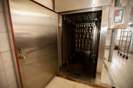 Industrial smoking of fish. Mackerel in a smoking oven.