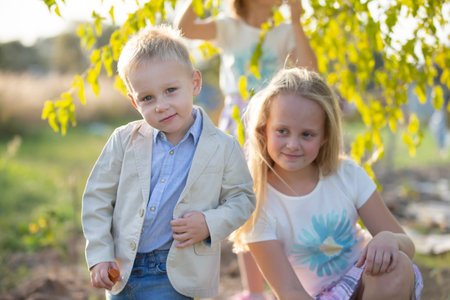 Little boy in a suit on the background of his sister.の写真素材