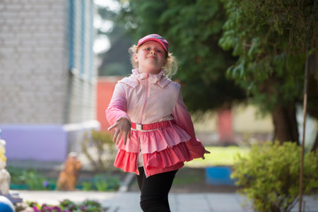 Belarus, the city of Gomil, May 30, 2019. Open day in kindergarten. Cheerful preschool girl runs along the path.のeditorial素材