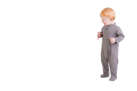 On a white background, a funny baby in growth with a surprised look.の写真素材