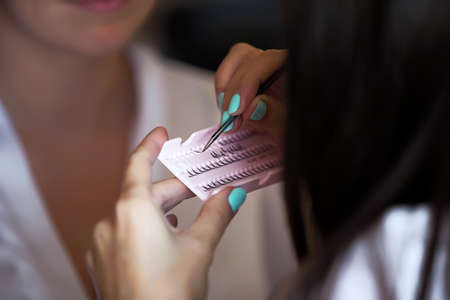 The make-up artist takes false eyelashes. Eyelash Set