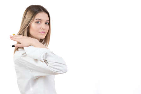 Girl in a white shirt on a white background. Young woman with a smart face.
