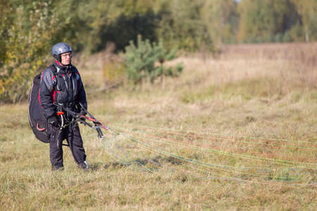 Belarus city Gomel October 7, 2018. Performances on paragliding.Paraglider paratrooper prepare to flyのeditorial素材