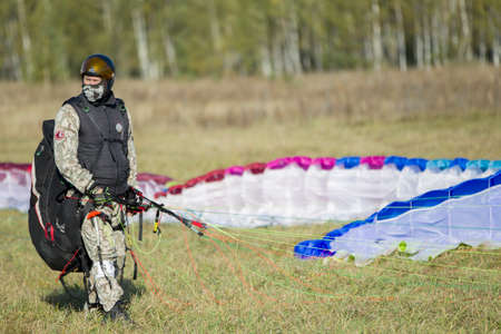 Belarus city Gomel October 7, 2018. Performances on paragliding.Paraglider paratrooper prepare to flyのeditorial素材