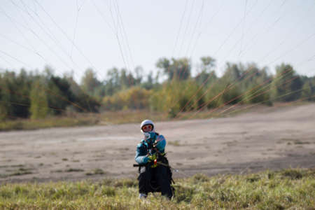 Belarus city Gomel October 7, 2018. Performances on paragliding.Paraglider paratrooper prepare to flyのeditorial素材