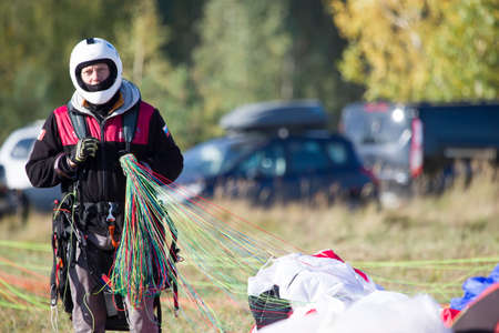 Belarus city Gomel October 7, 2018. Performances on paragliding.Paraglider paratrooper prepare to flyのeditorial素材
