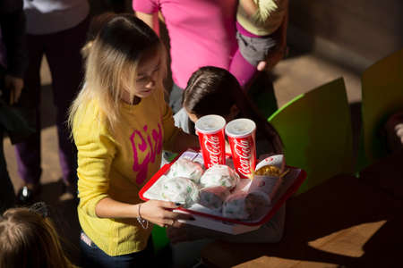 Belarus, Gomel, October 13, 2018. Holiday in the city. Children's Pavilion.Woman with fast food top viewのeditorial素材