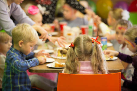 Belarus, Gomel, October 13, 2018. Holiday in the city. Children's Pavilion.Children's party. Birthday child with guests at the tableのeditorial素材