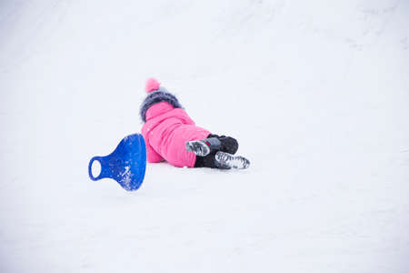Belarus, the city of Gomel, December 31, 2018. The central quarter. People ride on a snow slide.のeditorial素材