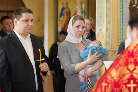 Belarus, Gomel, May 6, 2018. Church of Volotovo. Godparents in the church at the baptism of a...