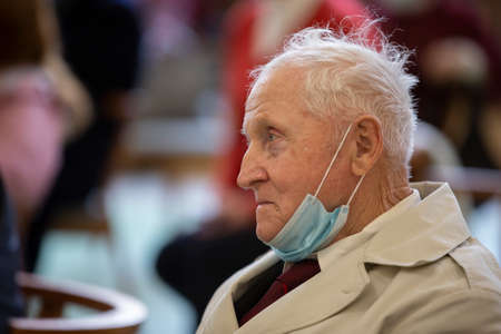 Belarus, the city of Gomil, April 17, 2021 Meeting Club of the elderly. An old man in a medical mask, shot in profile.のeditorial素材