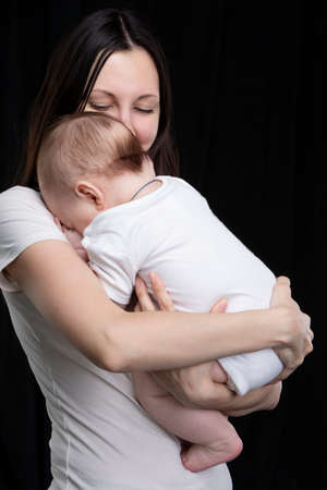 Beautiful mother hugs her baby. Motherhood.