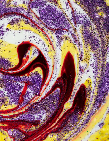 Yellow smeared in a circle with purple sparkles Abstract pattern with curls. Popular fashionable art design.の写真素材
