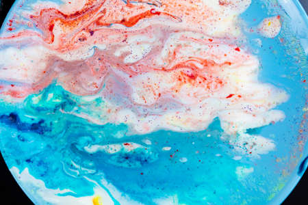 The background is acrylic soft blue with pink and sparkles. Colorful marble texture. Fluid liquid...