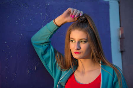 Portrait of a beautiful girl on a purple background.の写真素材
