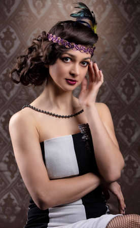 Retro woman portrait. Beautiful lady in 20s or 30s style. Old fashionable Finger Wave makeup and...