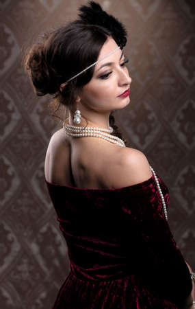 Retro woman portrait. Luxurious lady in vintage style from 20s or 30s. Photo of a girl in vintage...